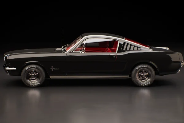 Side-view 3D render of a black classic Mustang fastback with red interior and BFGoodrich tyres in a dark studio