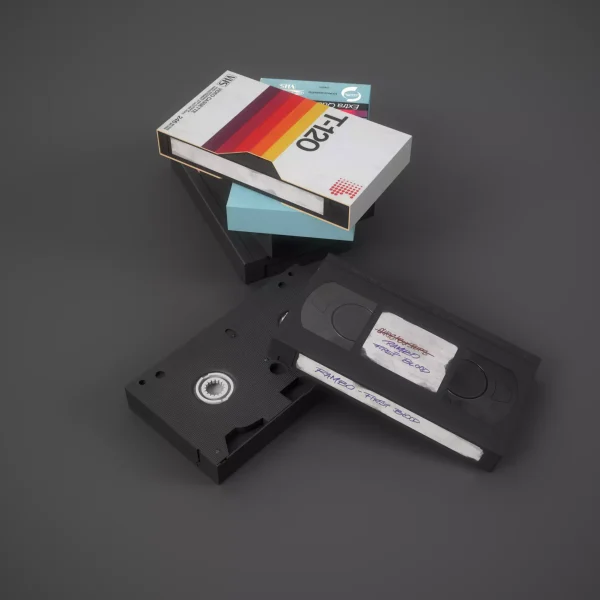 Photorealistic 3D render of VHS tapes with a retro striped sleeve and a handwritten label reading Rambo - First Blood