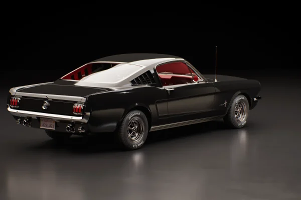 Three-quarter rear 3D render of a black classic Mustang fastback with red interior on a dark studio floor