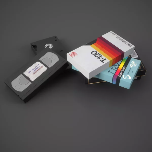 3D render of a black VHS cassette with a handwritten sticker beside stacked T-120 video cassette sleeves